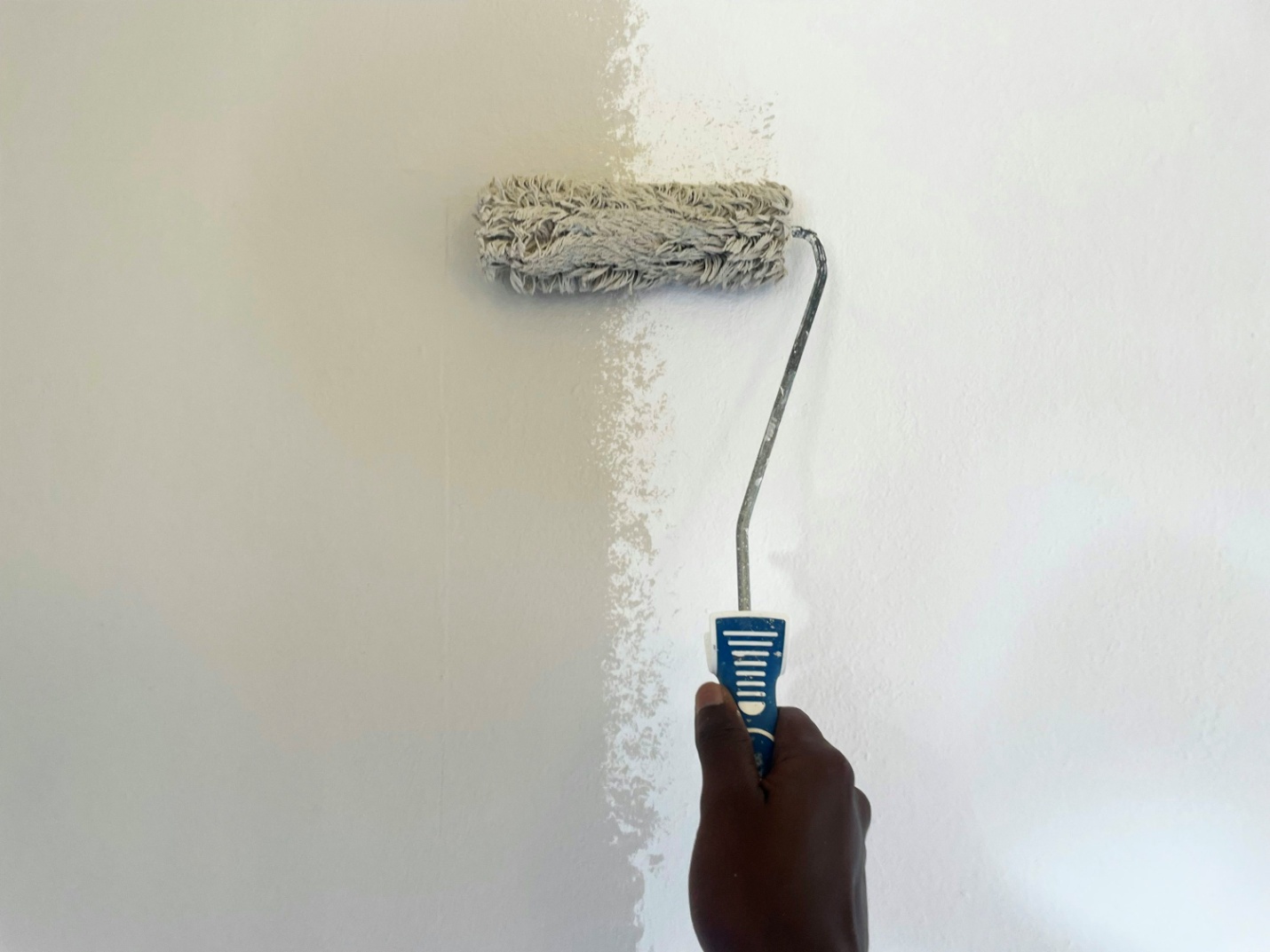 A person using a paint roller