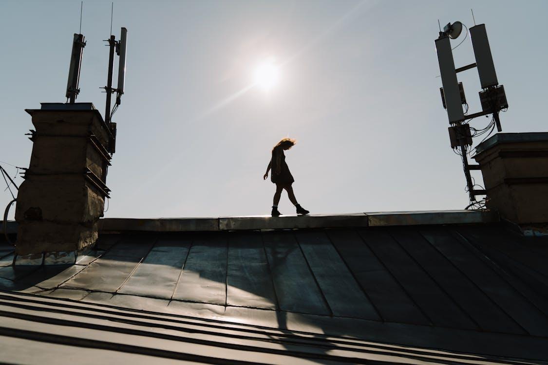 A person walking on a roof