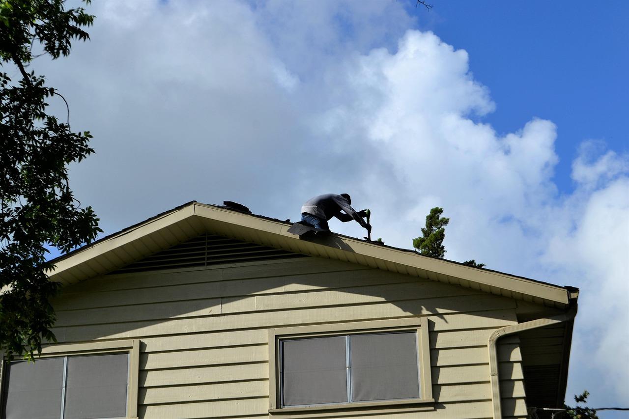 A roofer working on a property
