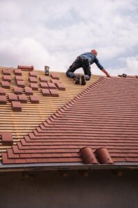 A roofer installing tiles