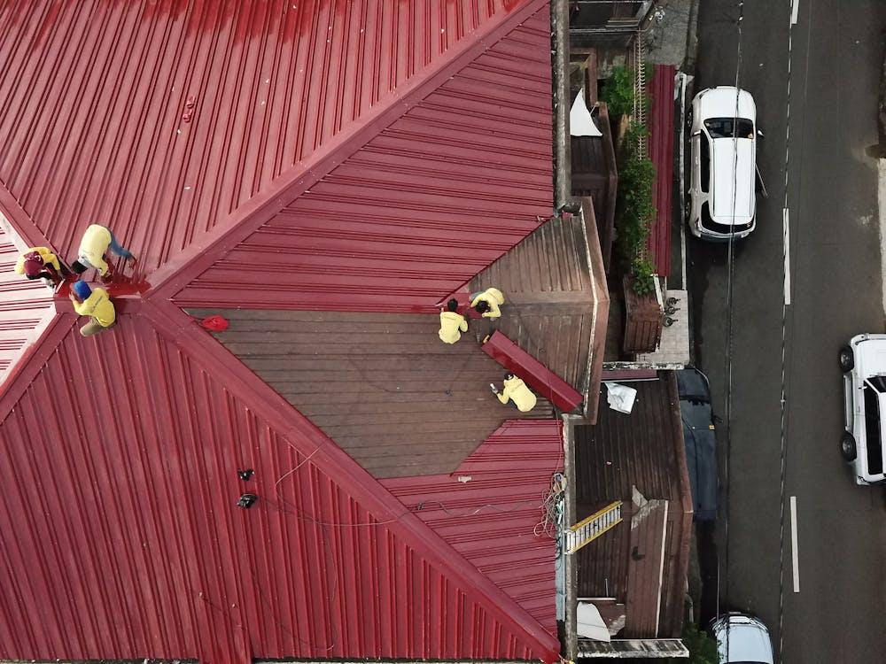 Roofers working on a metal roof