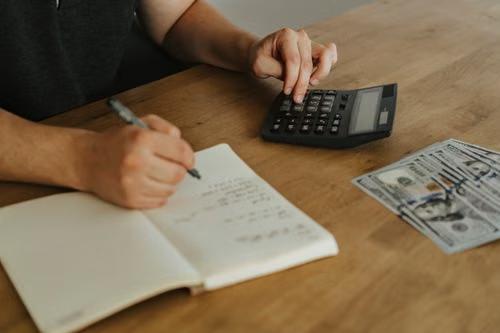 A person writing on a notebook
