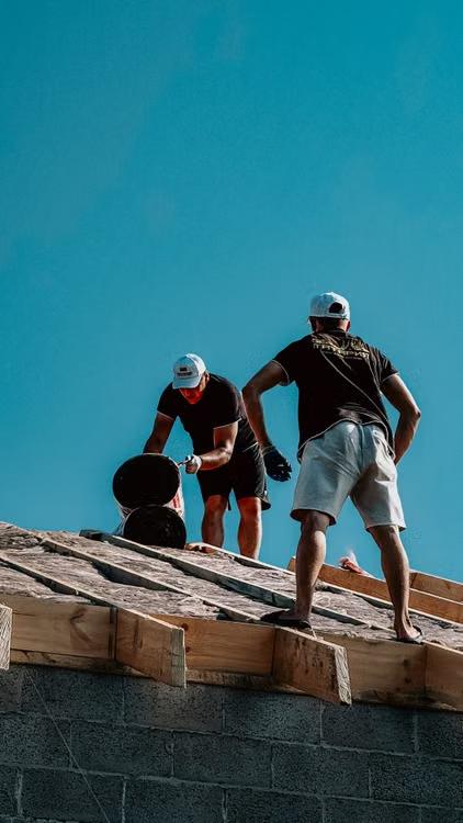 two men working on a roof