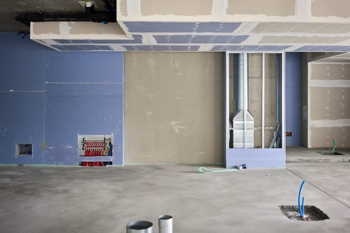 a room with exposed drywall and unfinished paint